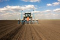 Farmer with tractor seeding crops at field Royalty Free Stock Photo