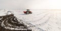 Farmer with tractor seeding - sowing crops at agricultural field Royalty Free Stock Photo