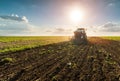 Farmer with tractor seeding - sowing crops at agricultural field Royalty Free Stock Photo