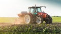 Farmer with tractor seeding - sowing crops at agricultural field Royalty Free Stock Photo