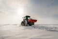 Farmer with tractor seeding - sowing crops at agricultural field Royalty Free Stock Photo