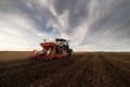 Farmer with tractor seeding