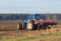 Farmer with tractor seeding - sowing crops at agricultural fields in spring Royalty Free Stock Photo