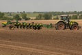 Farmer with tractor seeding - sowing crops at agricultural fields in spring Royalty Free Stock Photo