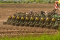 Farmer with tractor seeding - sowing crops at agricultural fields in spring Royalty Free Stock Photo