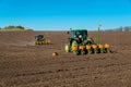 Farmer with tractor seeding - sowing crops at agricultural fields in spring Royalty Free Stock Photo