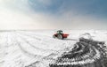 Farmer with tractor seeding - sowing crops at agricultural fields in winter Royalty Free Stock Photo