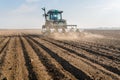 Farmer with tractor seeding - sowing soy crops at agricultural f