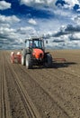 Farmer in tractor sowing corn maize crops. Royalty Free Stock Photo