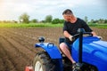A farmer on a tractor works in the field. Freeing milling earth ground from old crops. Land cultivation. Softening of the soil Royalty Free Stock Photo