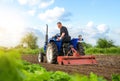 A farmer on a tractor works in the field. Milling soil, crushing and loosening ground. Working as a farmer. Farming. Preparatory Royalty Free Stock Photo