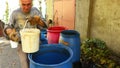 Farmer is transfuse fruit marc with plastic bucket