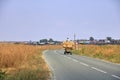 Farmer transporting hay with a horse-drawn cart from pastures to the farm on the roads of the village. Romanian traditions