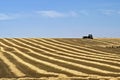 Farmer transporting straw bales in harvested field Royalty Free Stock Photo