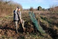 Farmer Turning Soil in Winter