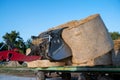 Farmer unloading round bales of straw with a front end loader
