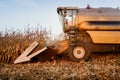 Farmer using combine harvester working the fields and harvesting corn Royalty Free Stock Photo