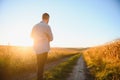 Farmer walking in corn fields with beautiful sunset Royalty Free Stock Photo