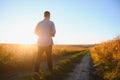 Farmer walking in corn fields with beautiful sunset Royalty Free Stock Photo