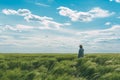 Farmer walking through a green wheat field