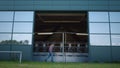 Farmer walking milking equipment parlor. Dairy production worker inspecting