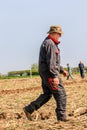 Farmer walking in ploughed field