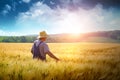 Farmer walking through a wheat field