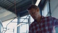 Farmer washing hands working with milking device using hose on dairy manufacture