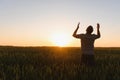 Farmer in wheat field planning harvest activity, female agronomist looking at sunset on the horizon. Royalty Free Stock Photo