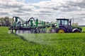 Farmer wheat field spraying herbicides