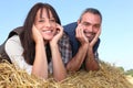 Farmer and wife laying in hay Royalty Free Stock Photo