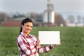 Farmer woman on corn field holding blank sign Royalty Free Stock Photo