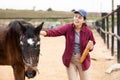 Farmer woman feeding horse with bread in farm Royalty Free Stock Photo