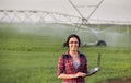 Farmer woman in front of watering system Royalty Free Stock Photo