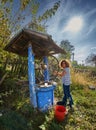 Farmer woman getting water from a well Royalty Free Stock Photo