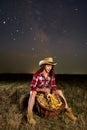 Farmer woman with her basket under starry sky Royalty Free Stock Photo