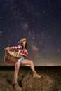 Farmer woman with her basket under starry sky Royalty Free Stock Photo