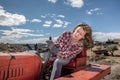 Farmer woman maneuvering a tractor on her farm