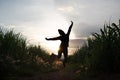 woman silhouette jump in the sugar cane plantation in the background sunset evening