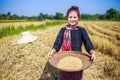 Farmer woman threshed rice in field Royalty Free Stock Photo