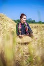 Farmer woman threshed rice in field Royalty Free Stock Photo