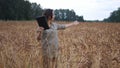 Farmer woman working with tablet on wheat field. agronomist with tablet talking on video communication reporting data of Royalty Free Stock Photo