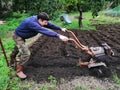 Farmer at work ploughing virgin soil.