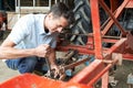 Farmer Working On Agricultural Equipment In Barn Royalty Free Stock Photo