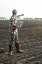 farmer working on his laptop in agricultural field. Royalty Free Stock Photo