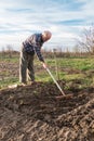 Farmer working with a rake in the garden Royalty Free Stock Photo