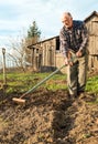 Farmer working with a rake in the garden Royalty Free Stock Photo