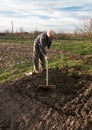 Farmer working with a rake in the garden Royalty Free Stock Photo