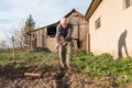 Farmer working with a rake in the garden Royalty Free Stock Photo