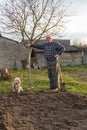 Farmer working with a rake in the garden Royalty Free Stock Photo